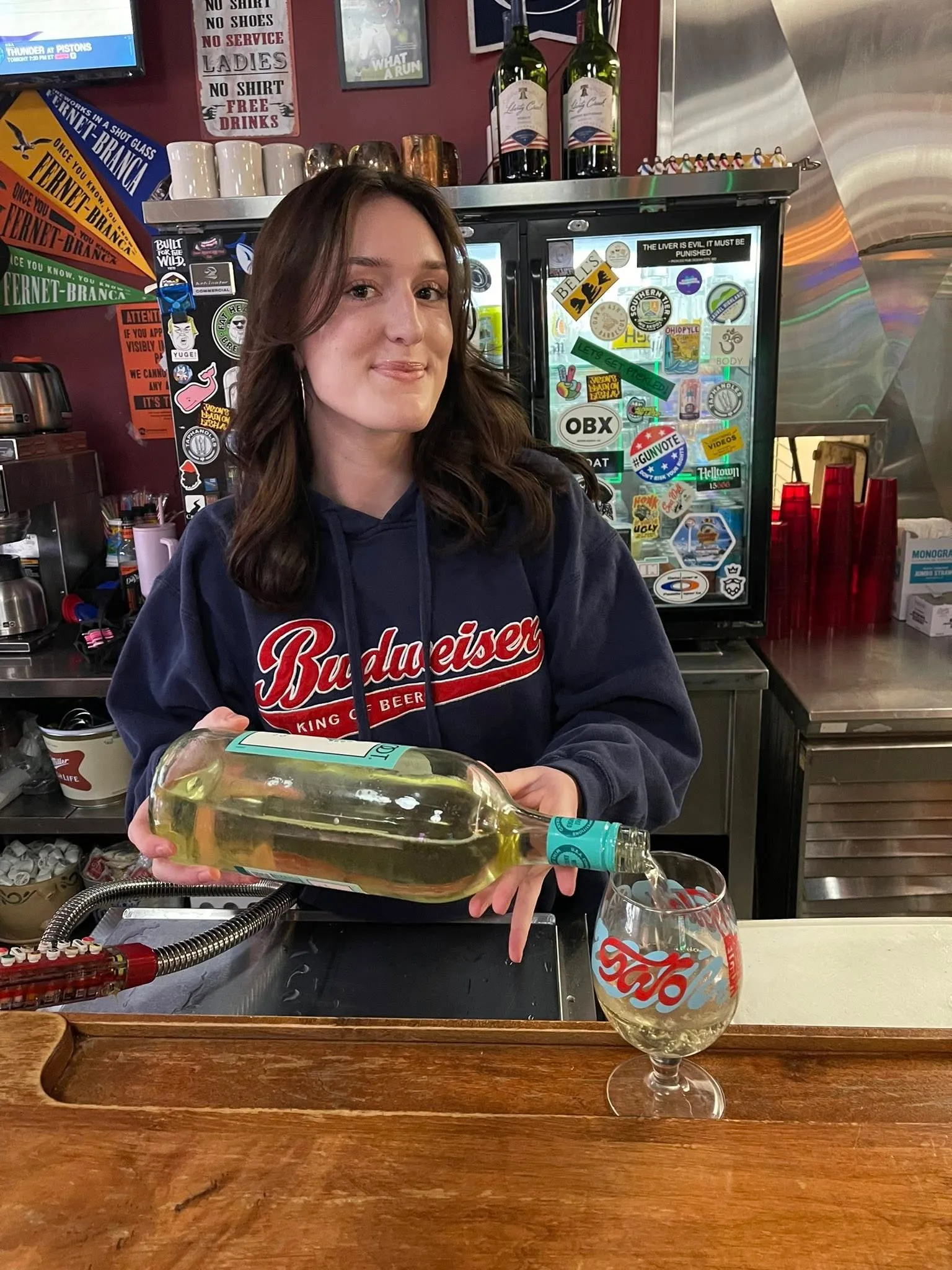 Bartender pouring wine into a Rizz's branded glass