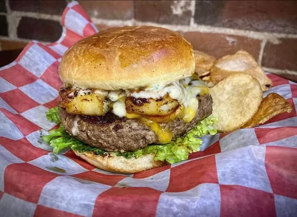 Rizz's burger with melted cheese and onion strings