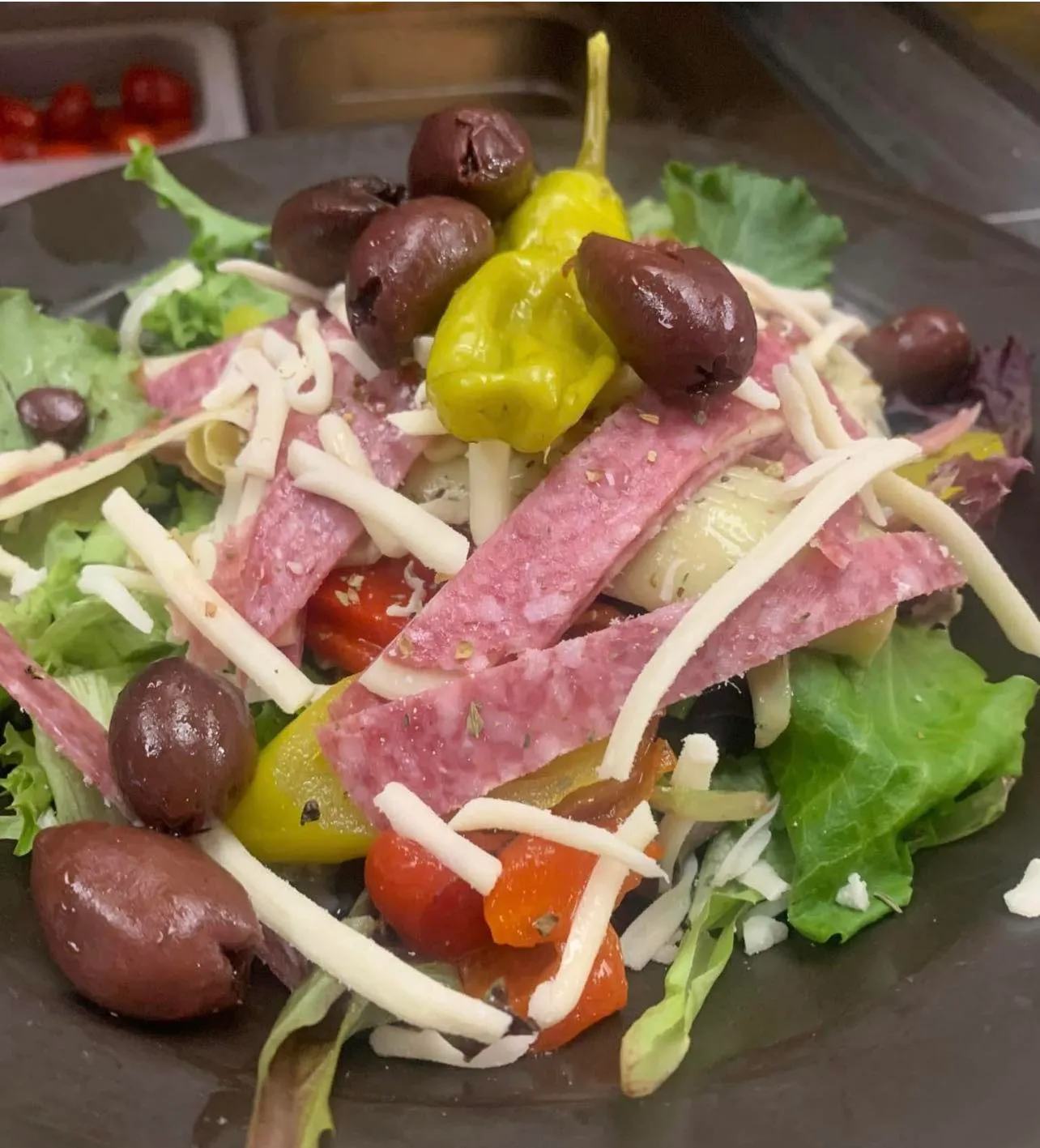 Antipasta salad — cured meats, fresh vegetables, olives, and house dressing