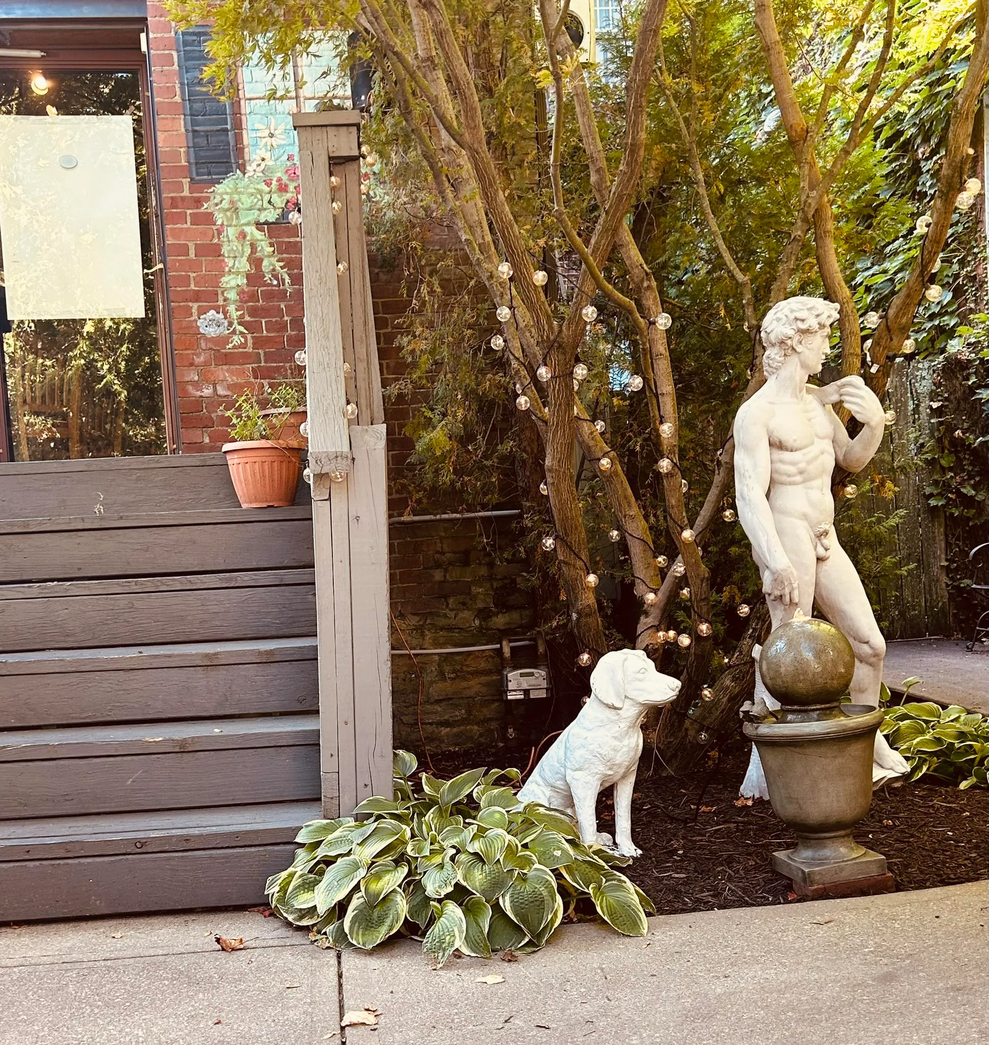 Rizz's patio out back — Statue of David, dog statue, fall trees