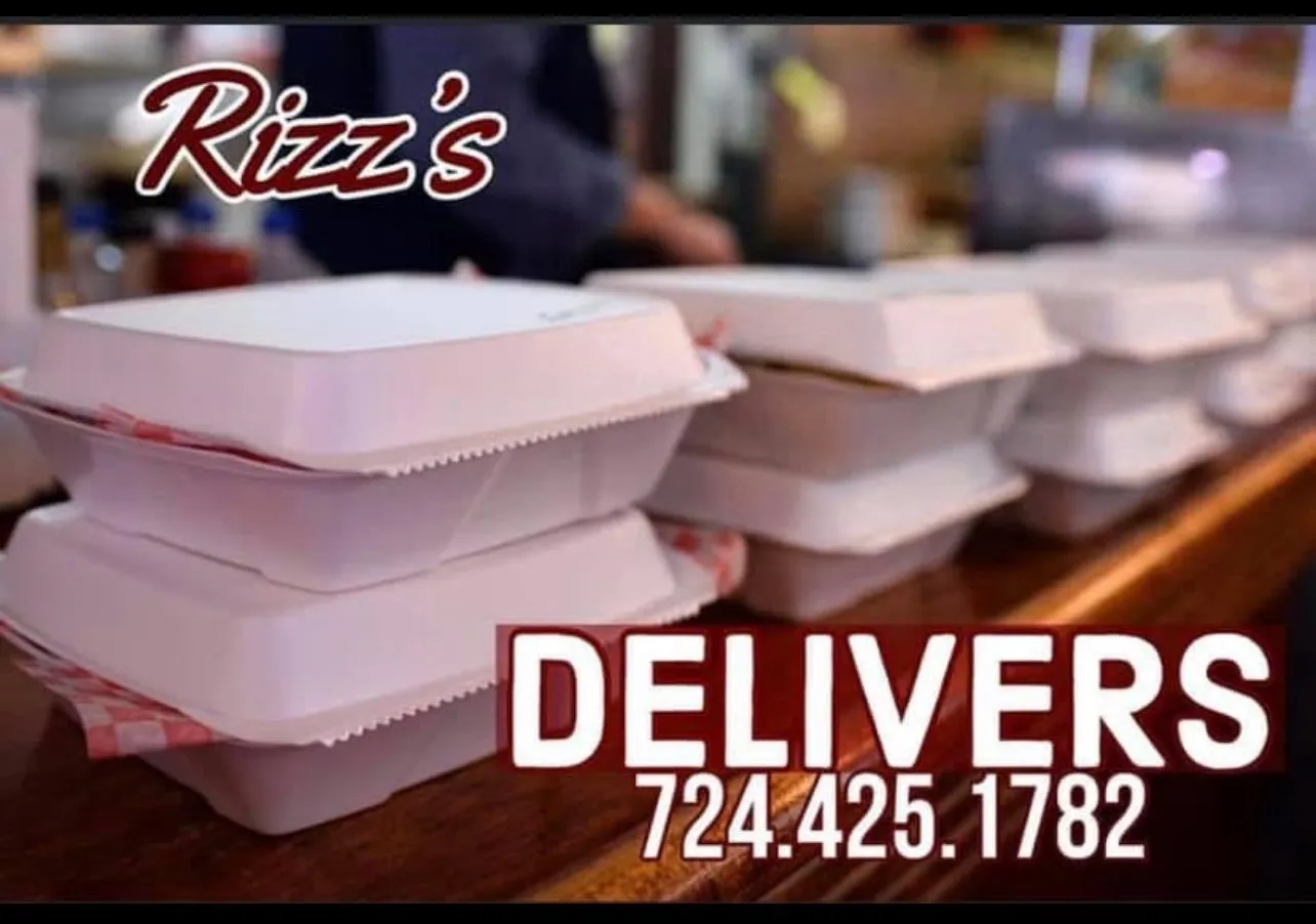 Stacked Rizz's branded delivery boxes ready to head out