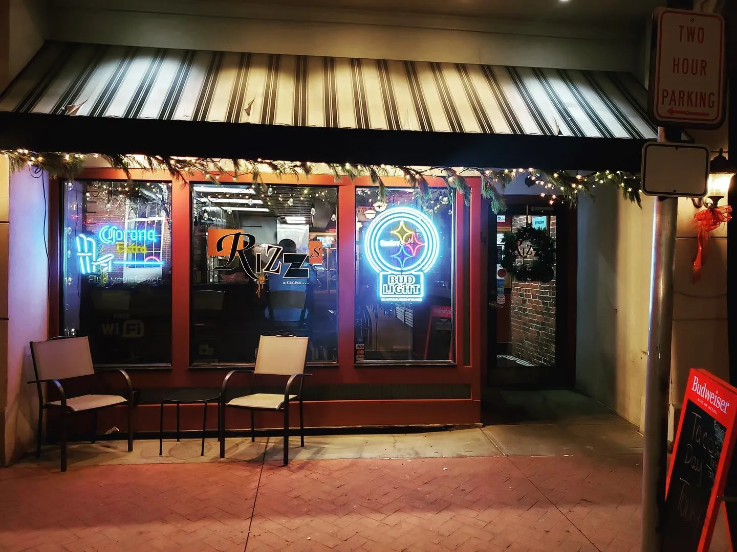 Storefront at night with garland and Corona light